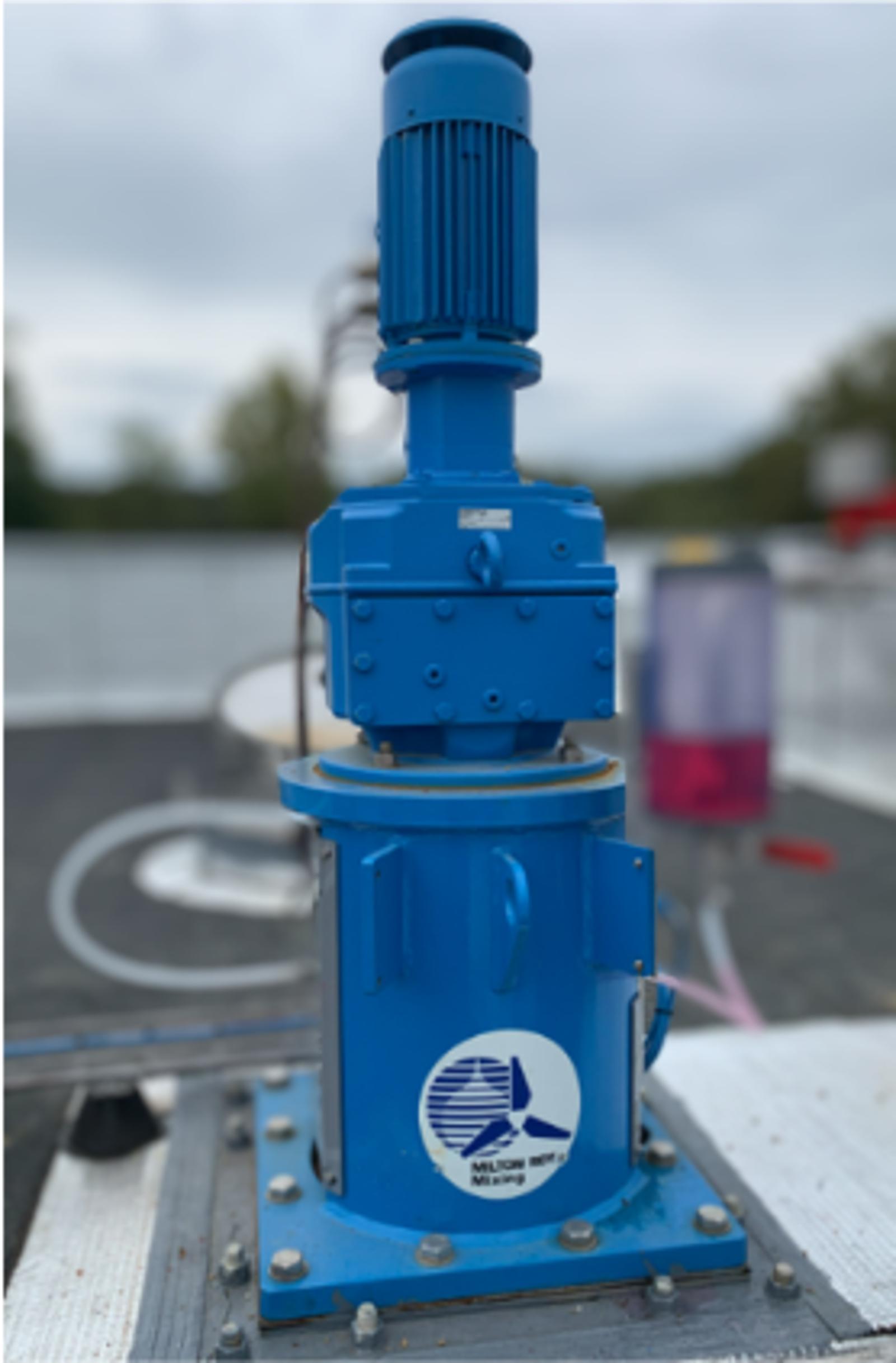 Muller Weingarten industrial machine with vertical motor and cylindrical base on metal platform