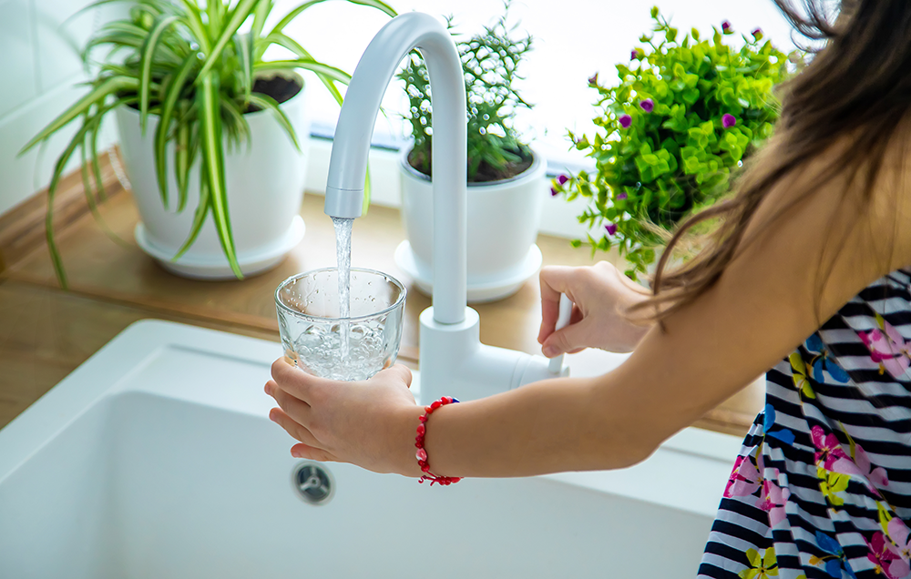 A girl is pouring tap water