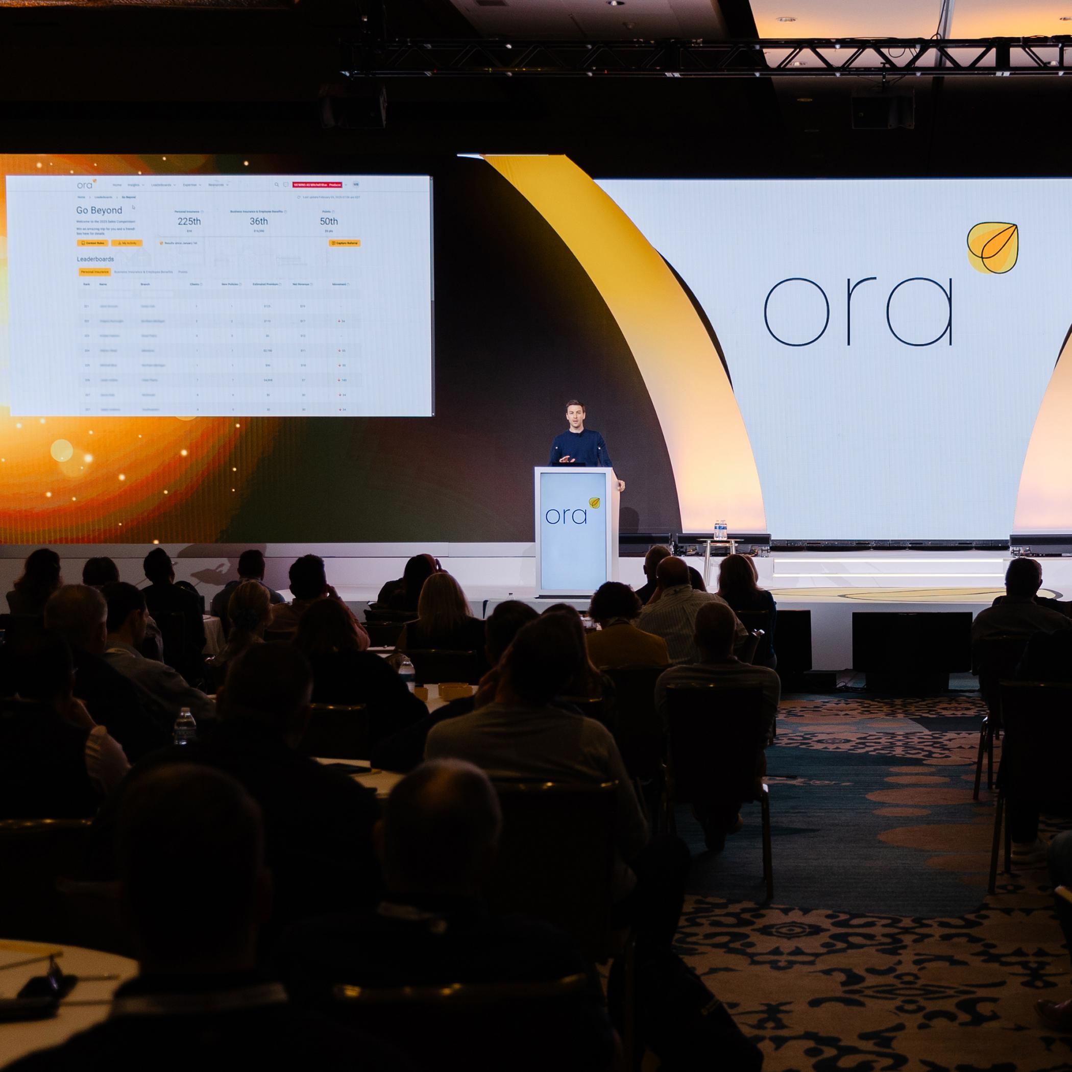 Hand of businesswoman holding smart phone near laptop in office.