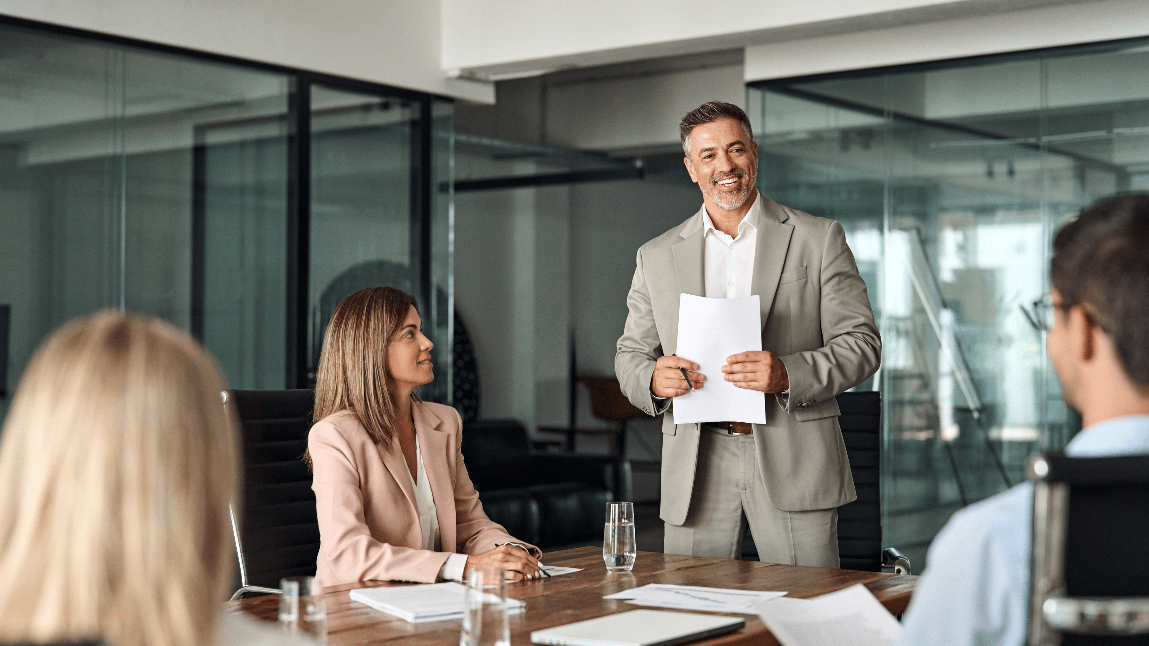 Happy mature older Latin business man team manager CEO executive leading group corporate meeting in board room.
