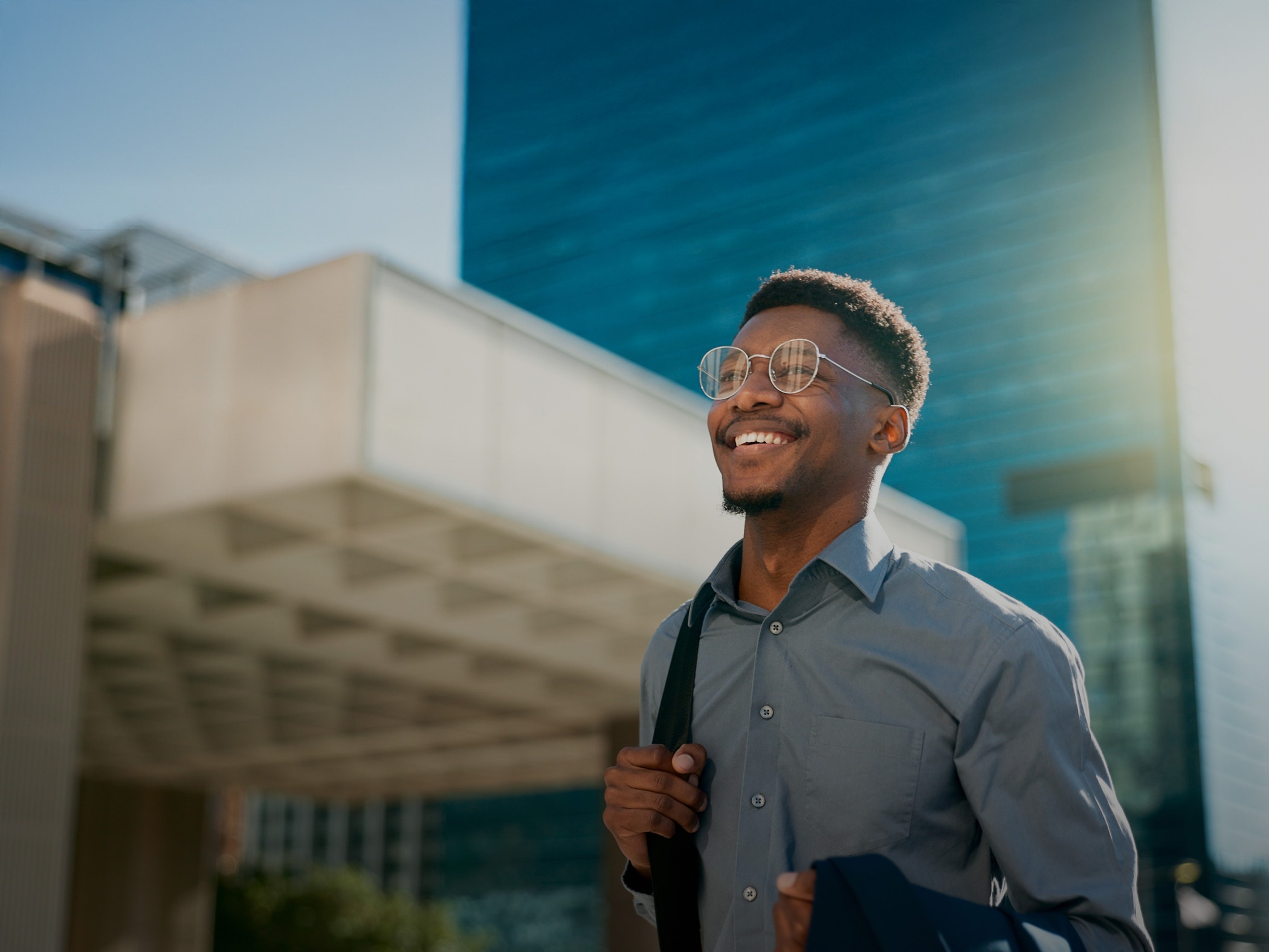 Business, happy and walking black man on city journey, commute trip and realtor smile on way to office building.