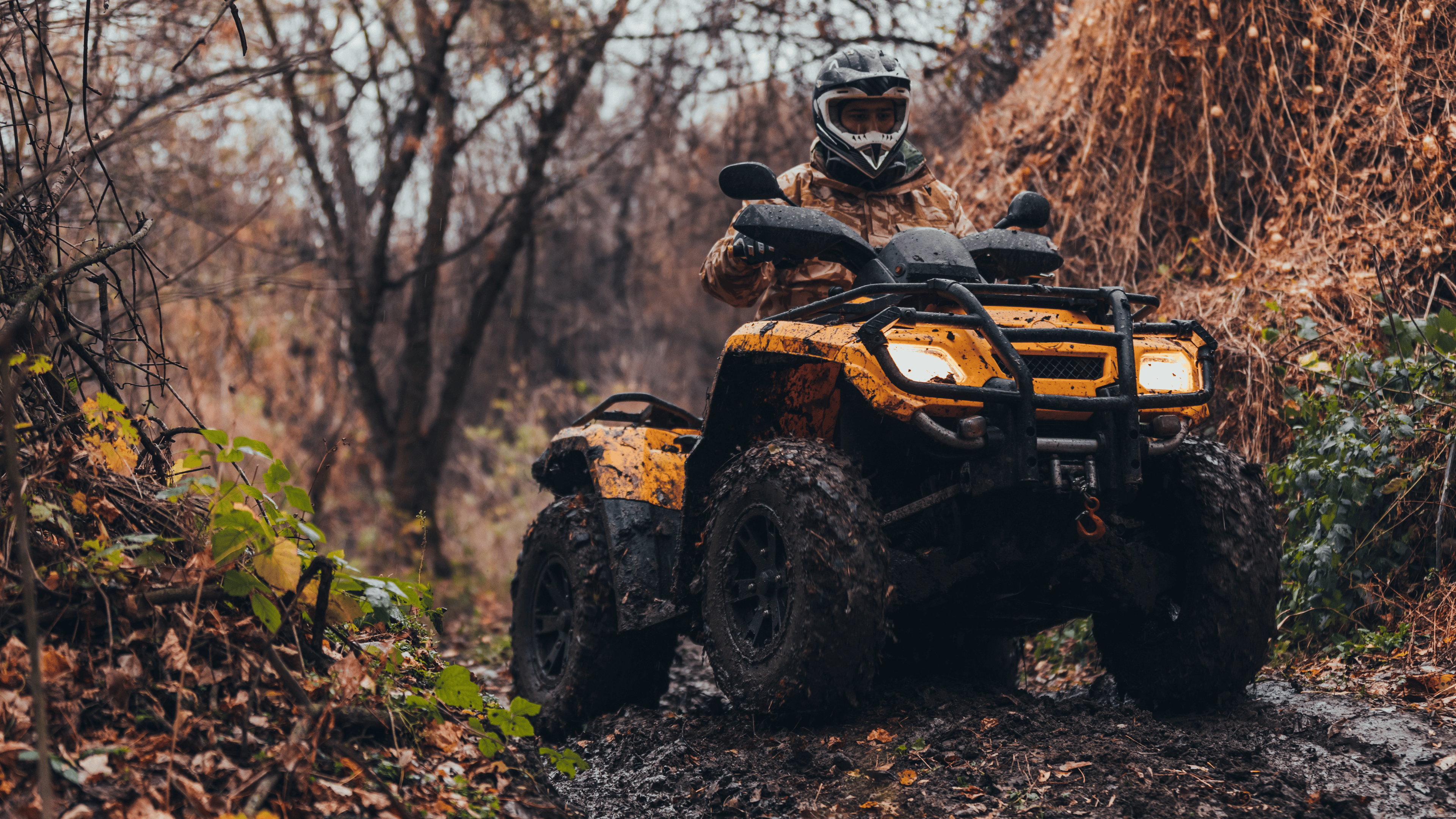 Unrecognizable person driving fix quad on a moody path