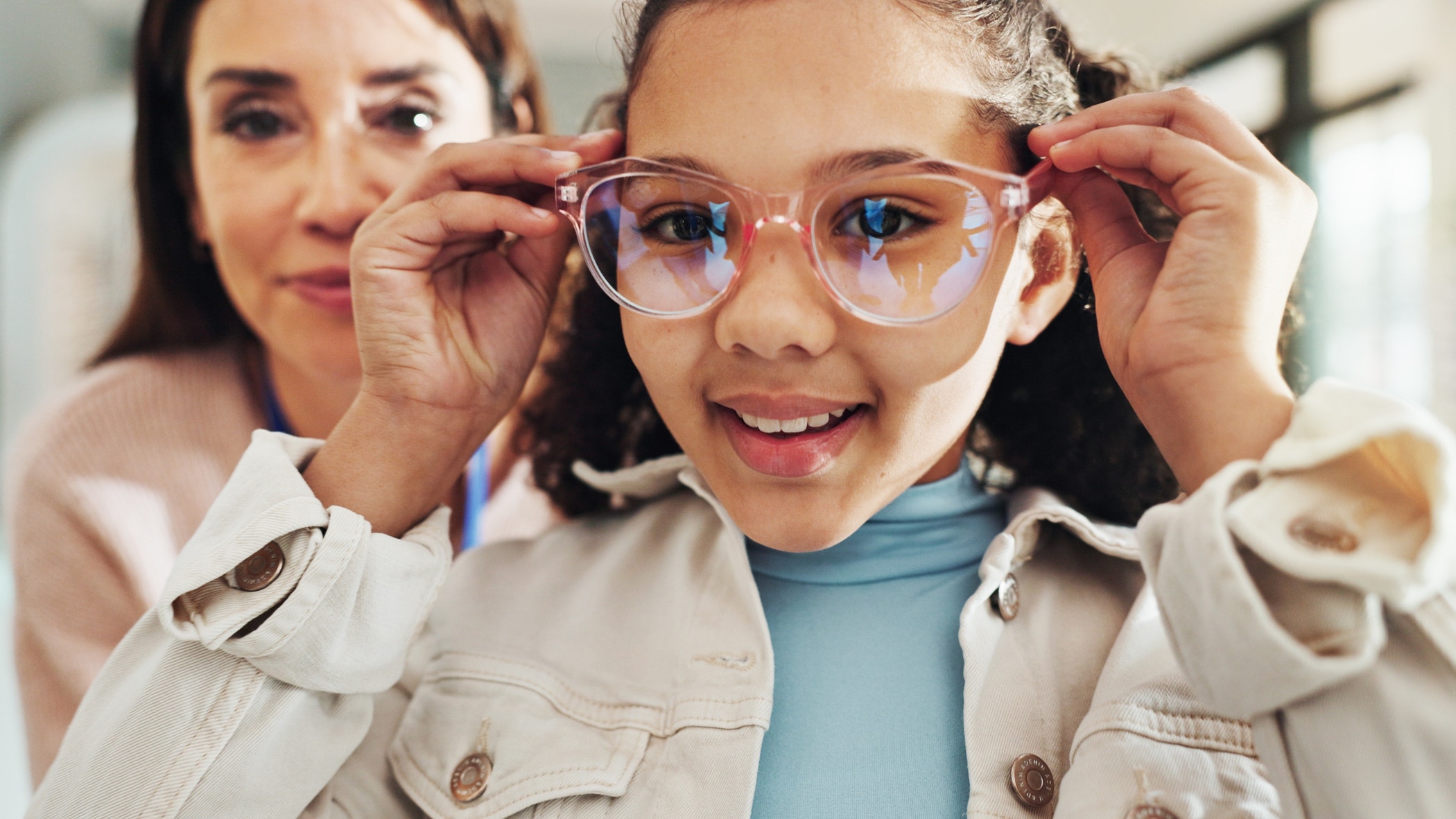 Eyewear, optometry and portrait of girl with woman in hospital for appointment, checkup and eye care.