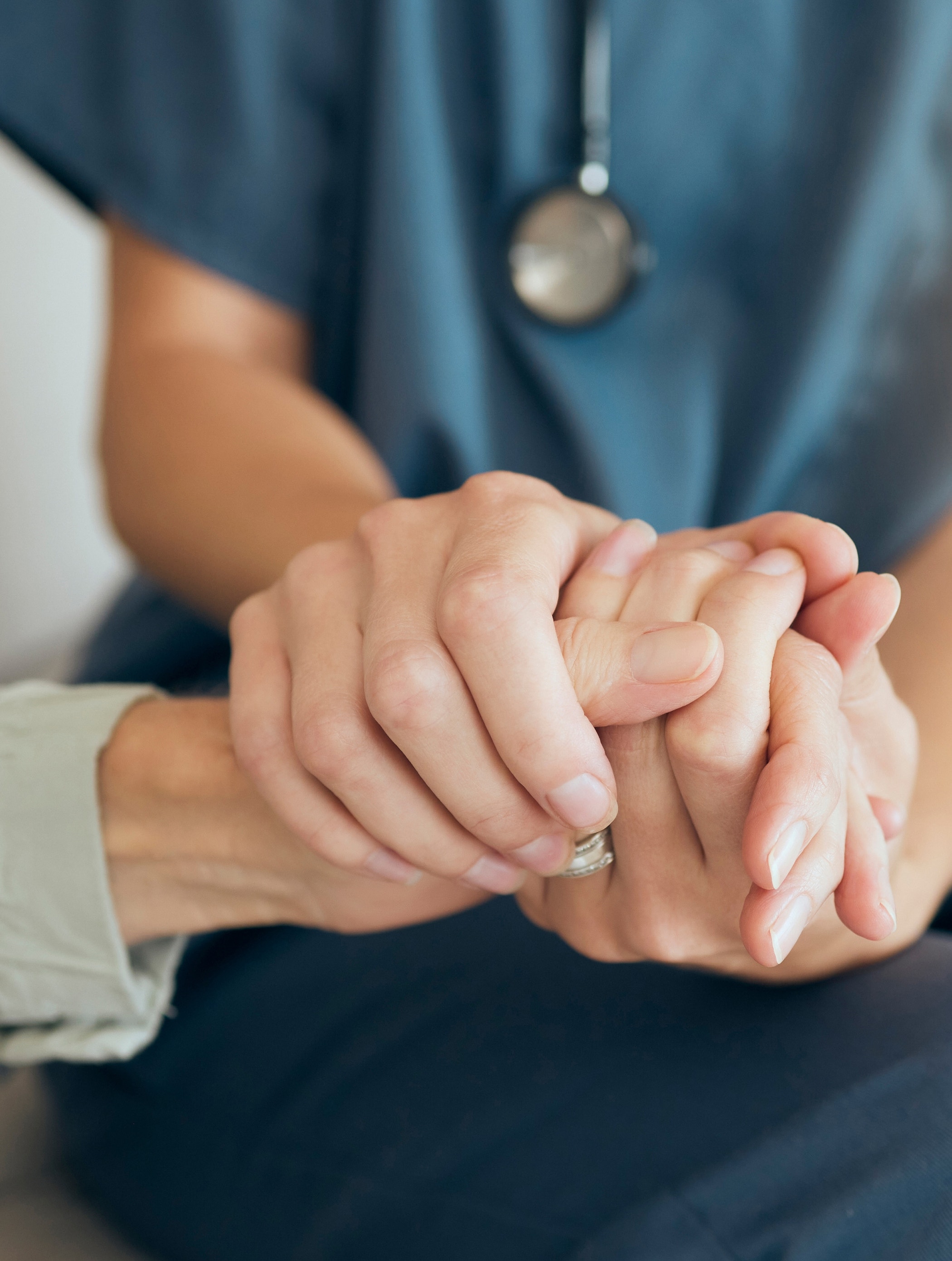 Senior care, woman and nurse or hand holding for comfort, assisted living and nursing home or retirement support.