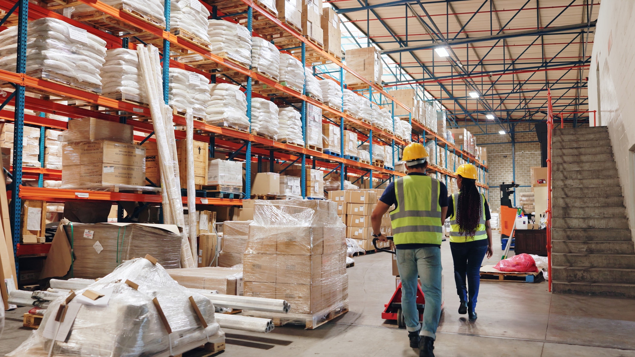 Large modern warehouse with forklifts.