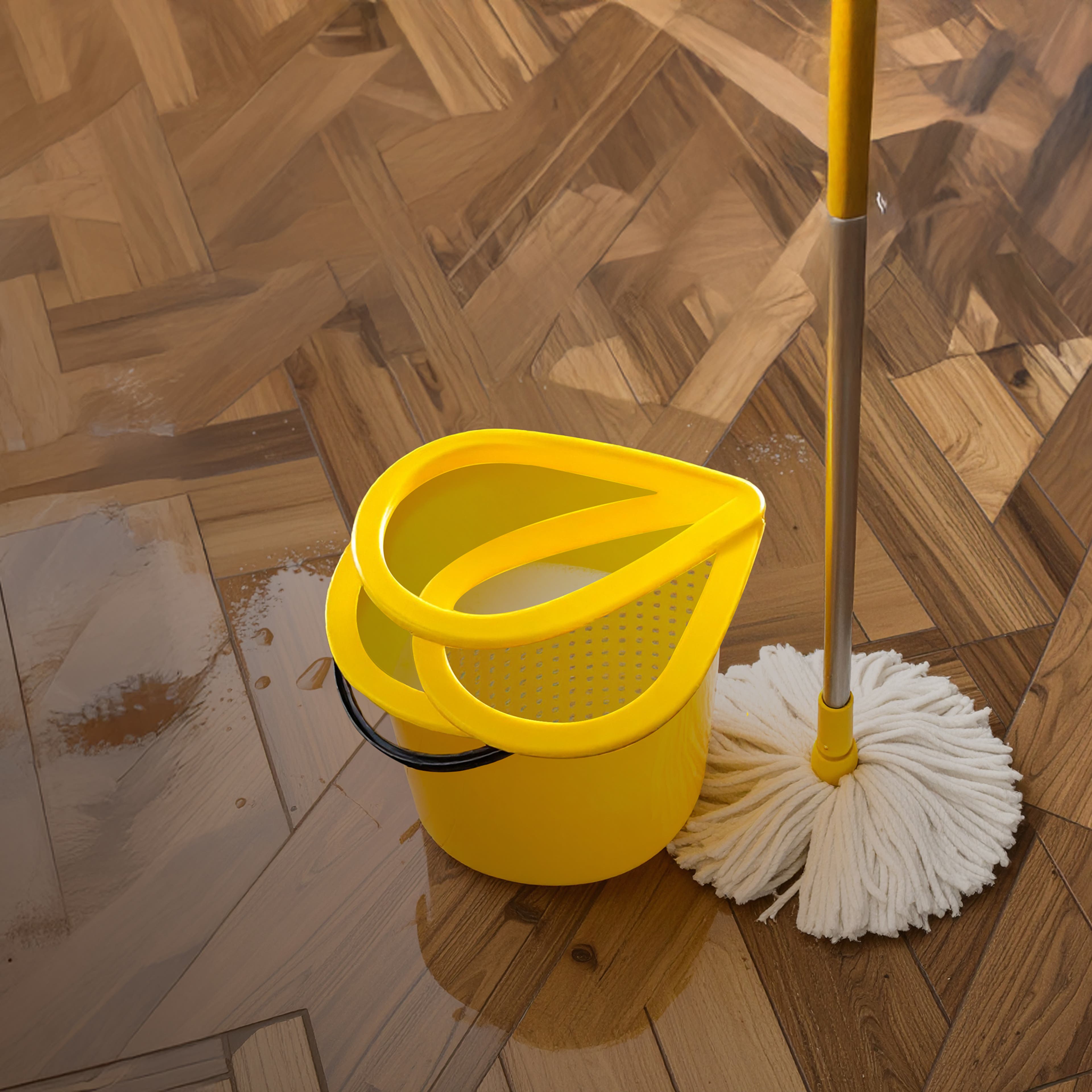 Yellow mop and bucket on a shiny wooden floor with water reflections.