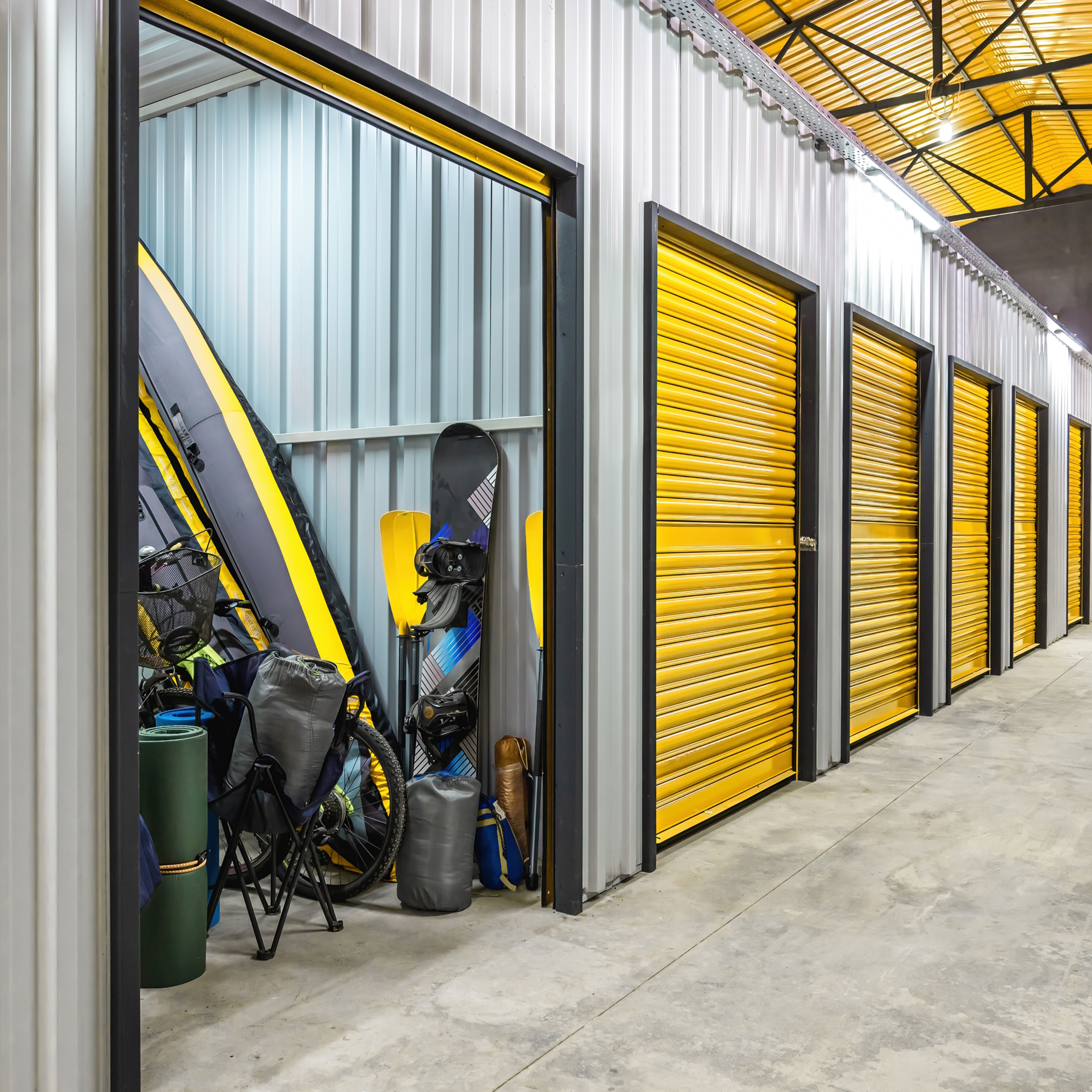 Corridor of self storage unit with yellow doors.