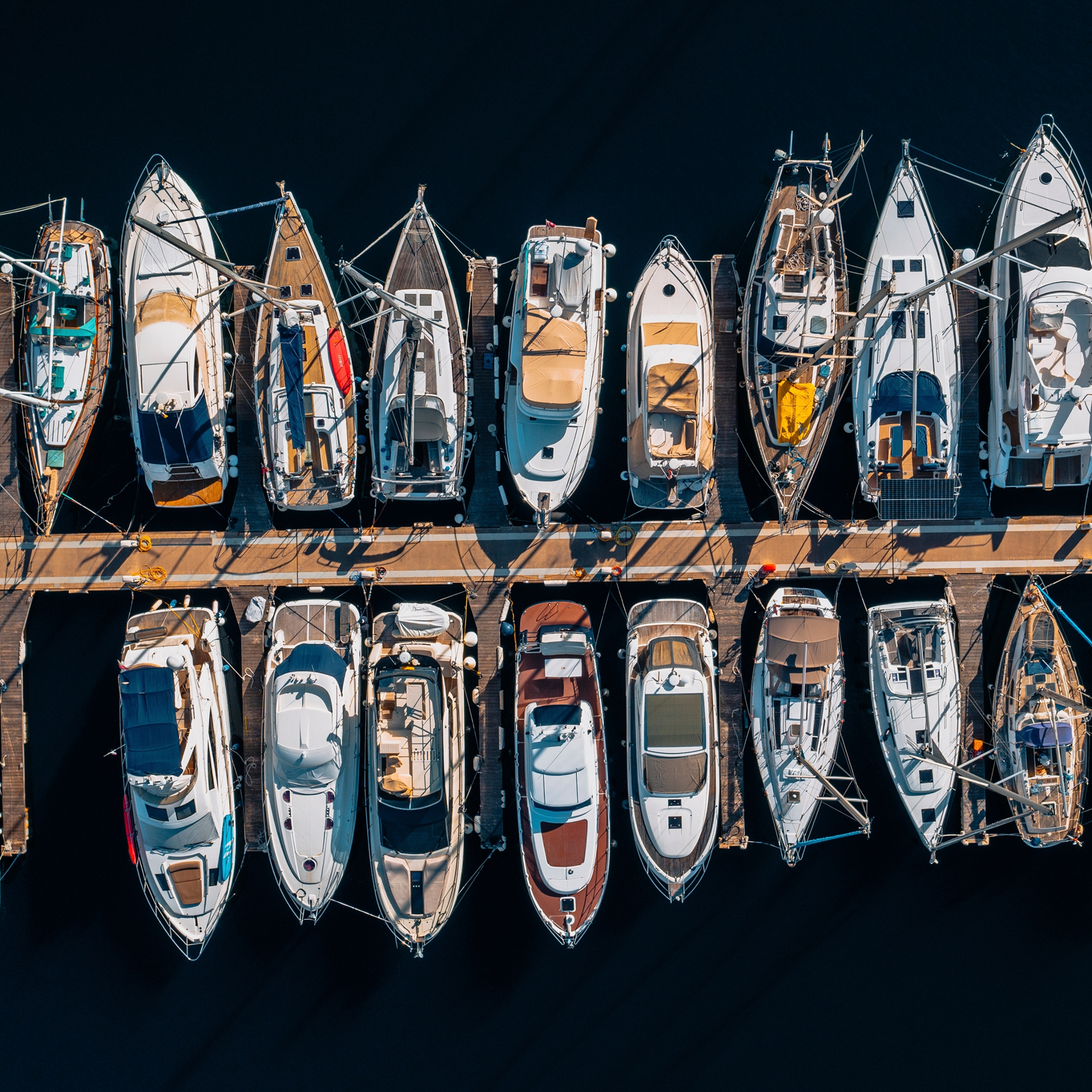 Aerial view of beautiful yacht marina with luxury boats moored at the dock.