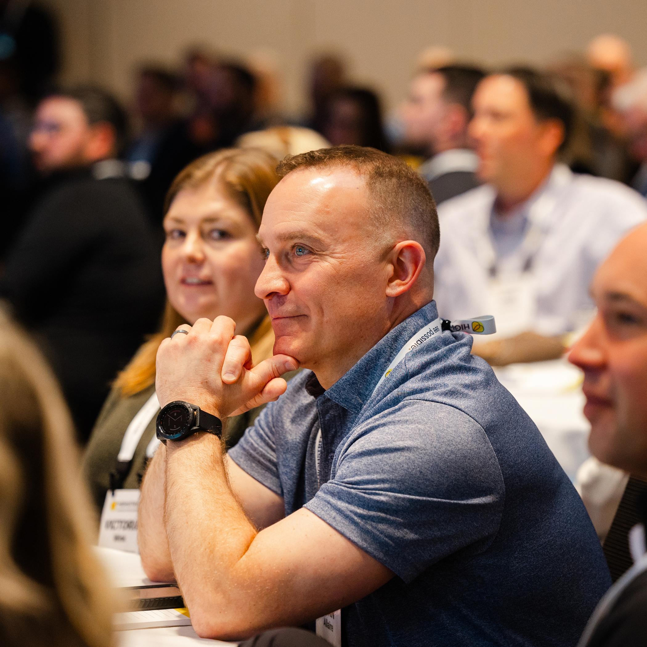 Audience members attentively listening during a conference session.