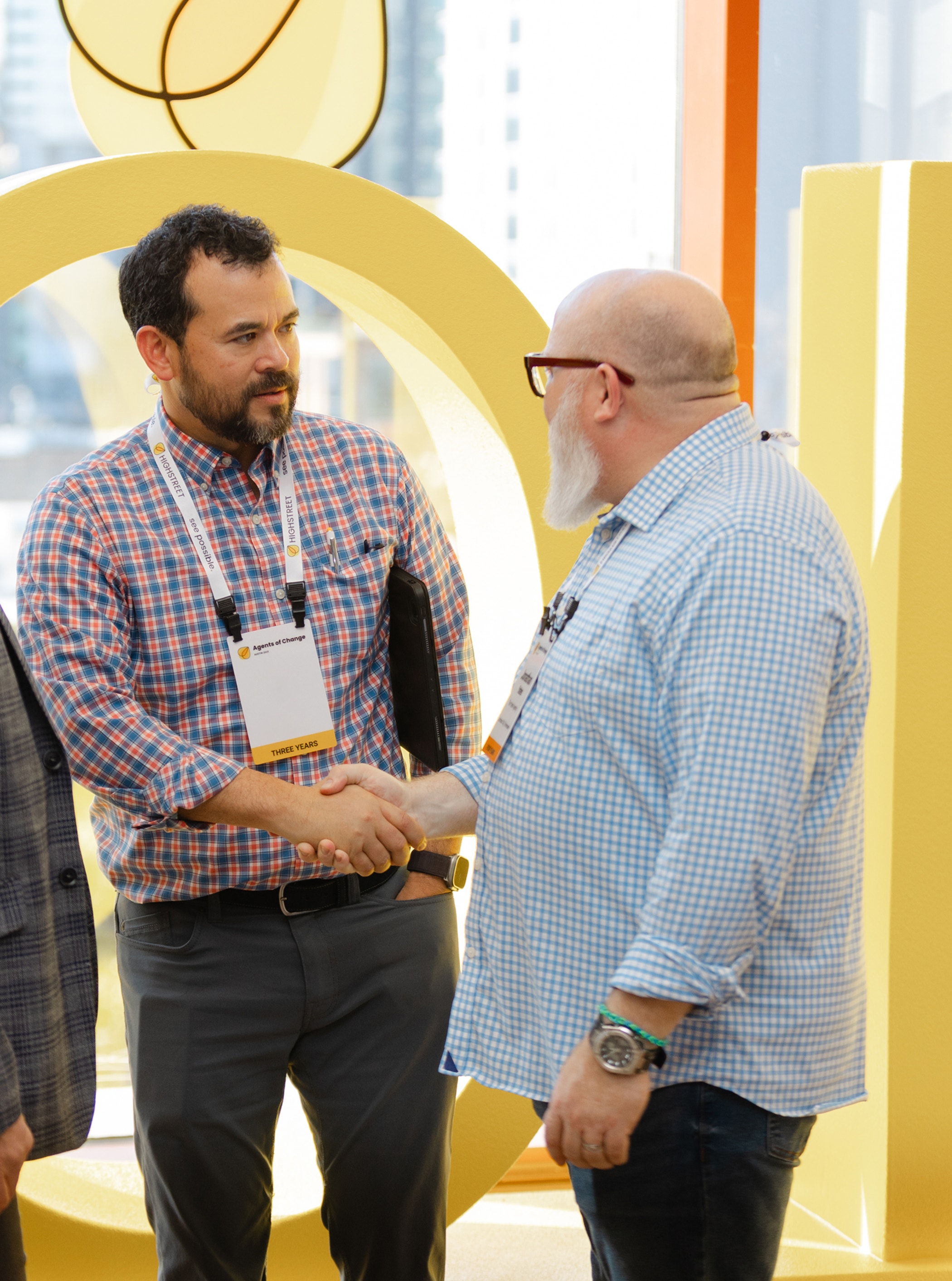Female business owner In workshop using digital tablet and holding mobile phone.