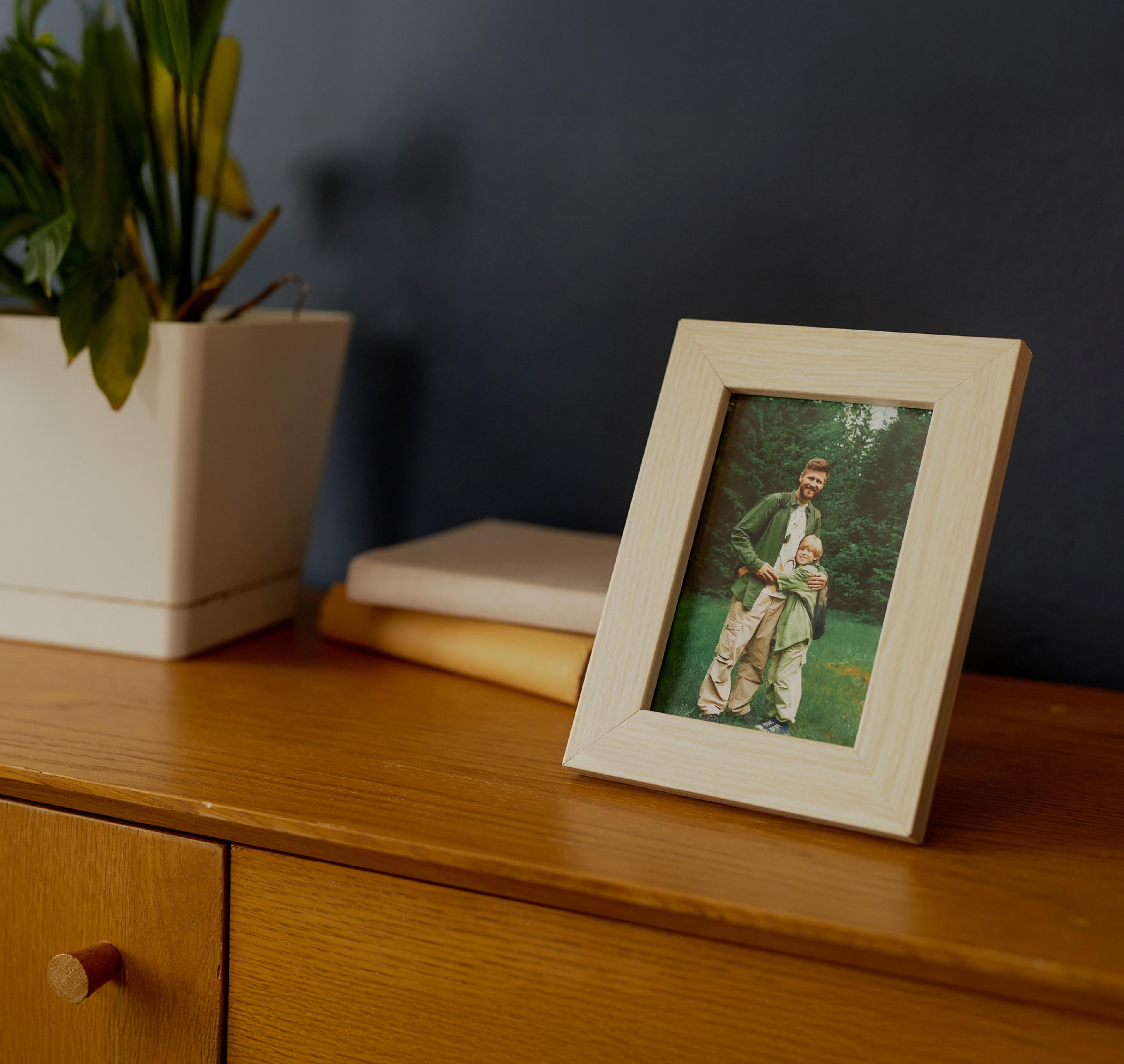 Framed photo of father and son on a dresser.