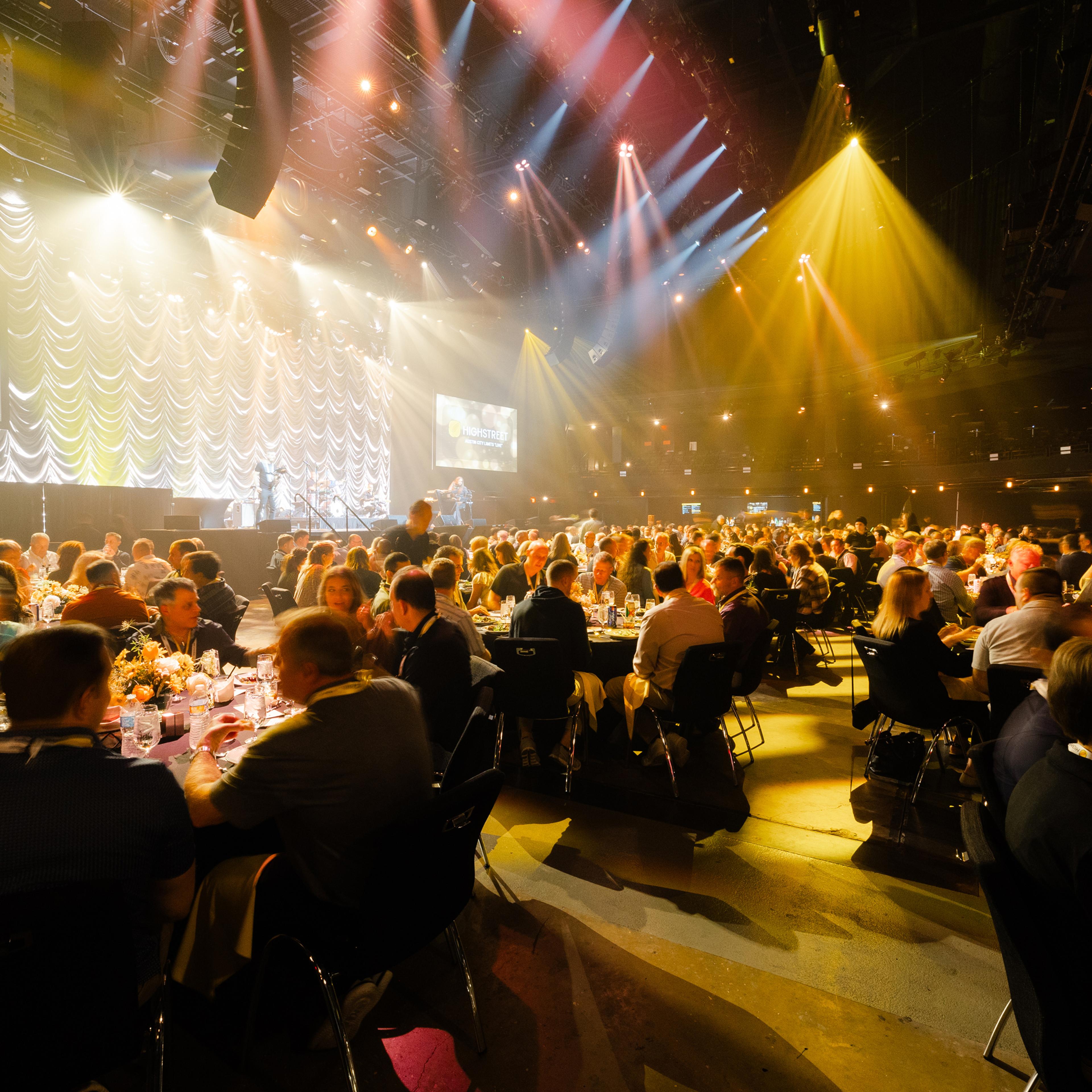 Audience seated and attentively listening during a conference session.