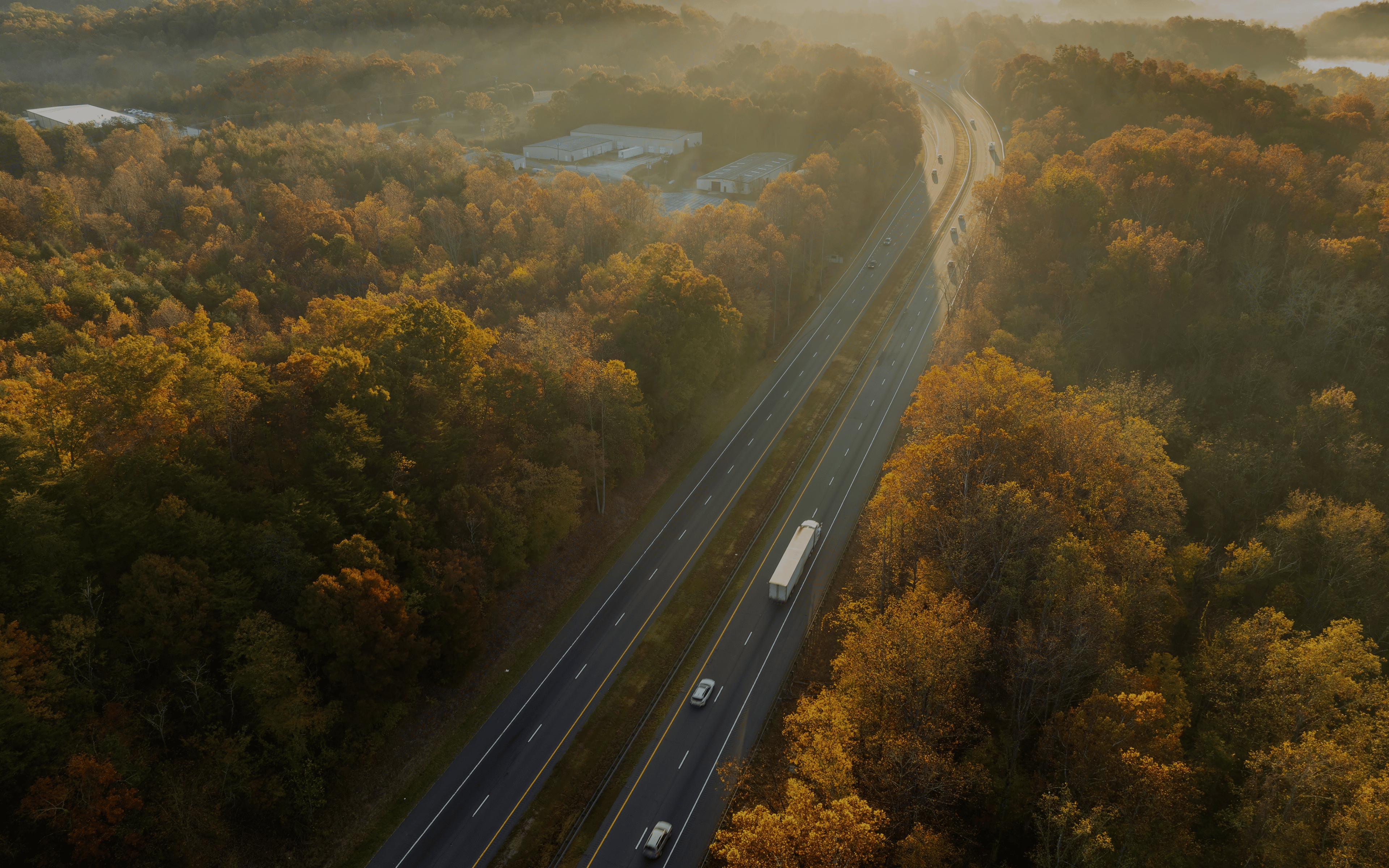 USA highway transportation infrastructure in North Carolina Appalachian mountains. American freeway road with fast driving semi trucks.