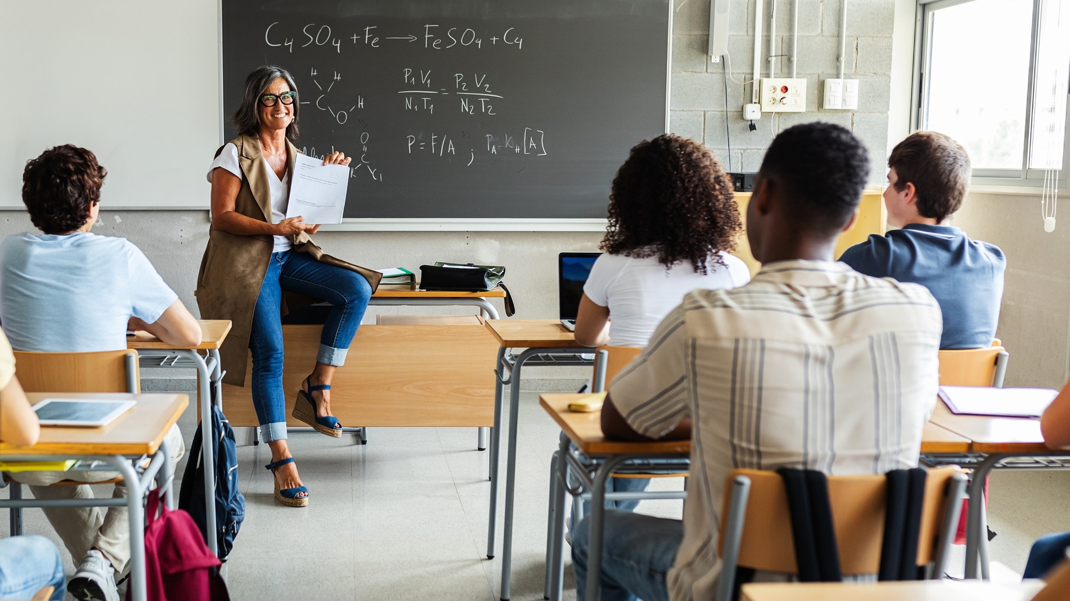 Young group of gen z students attending class at high school.