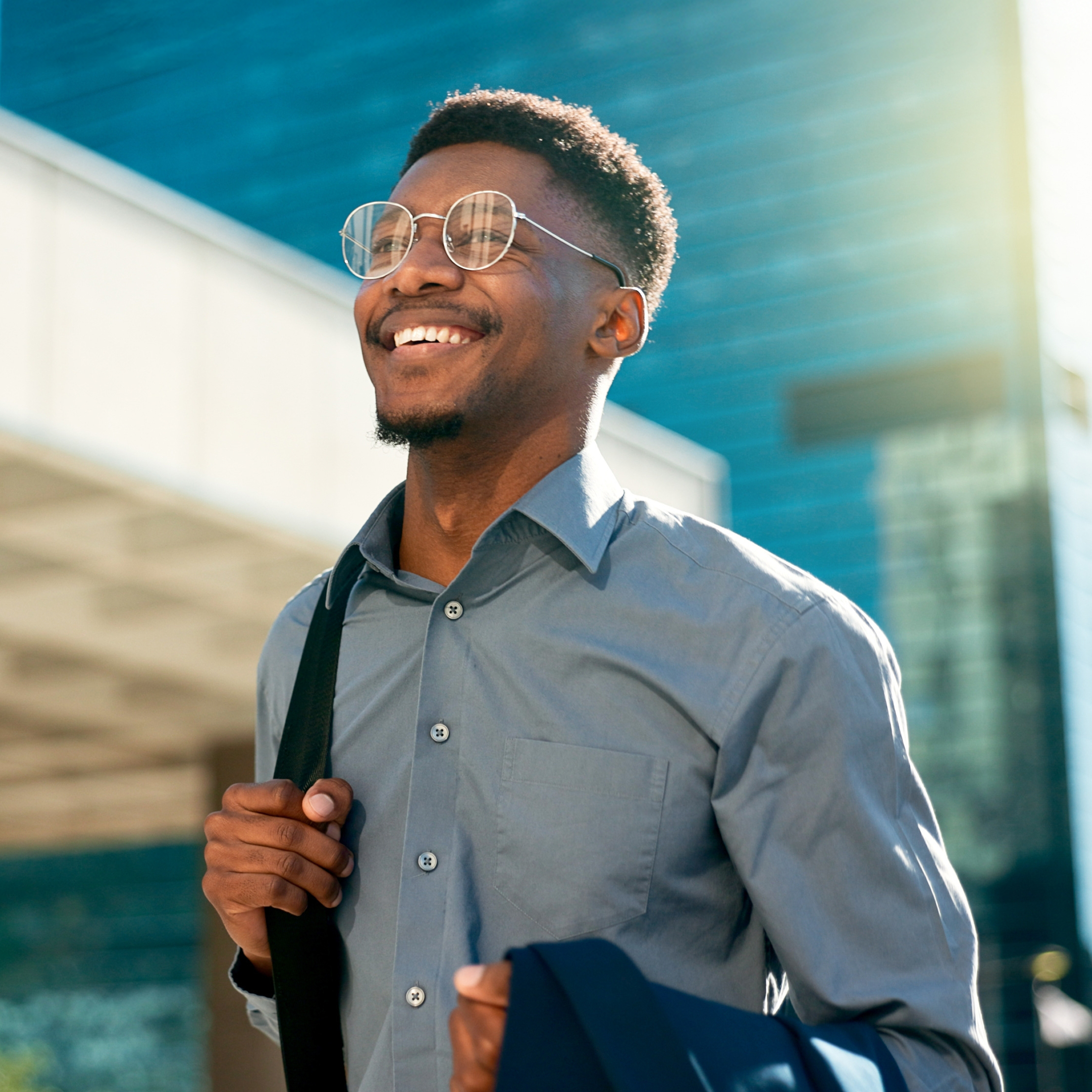Business, happy and walking black man on city journey, commute trip and realtor smile on way to office building.