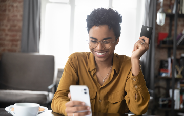 A person smiling while looking at a phone