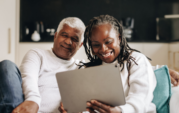 Two people looking at a tablet