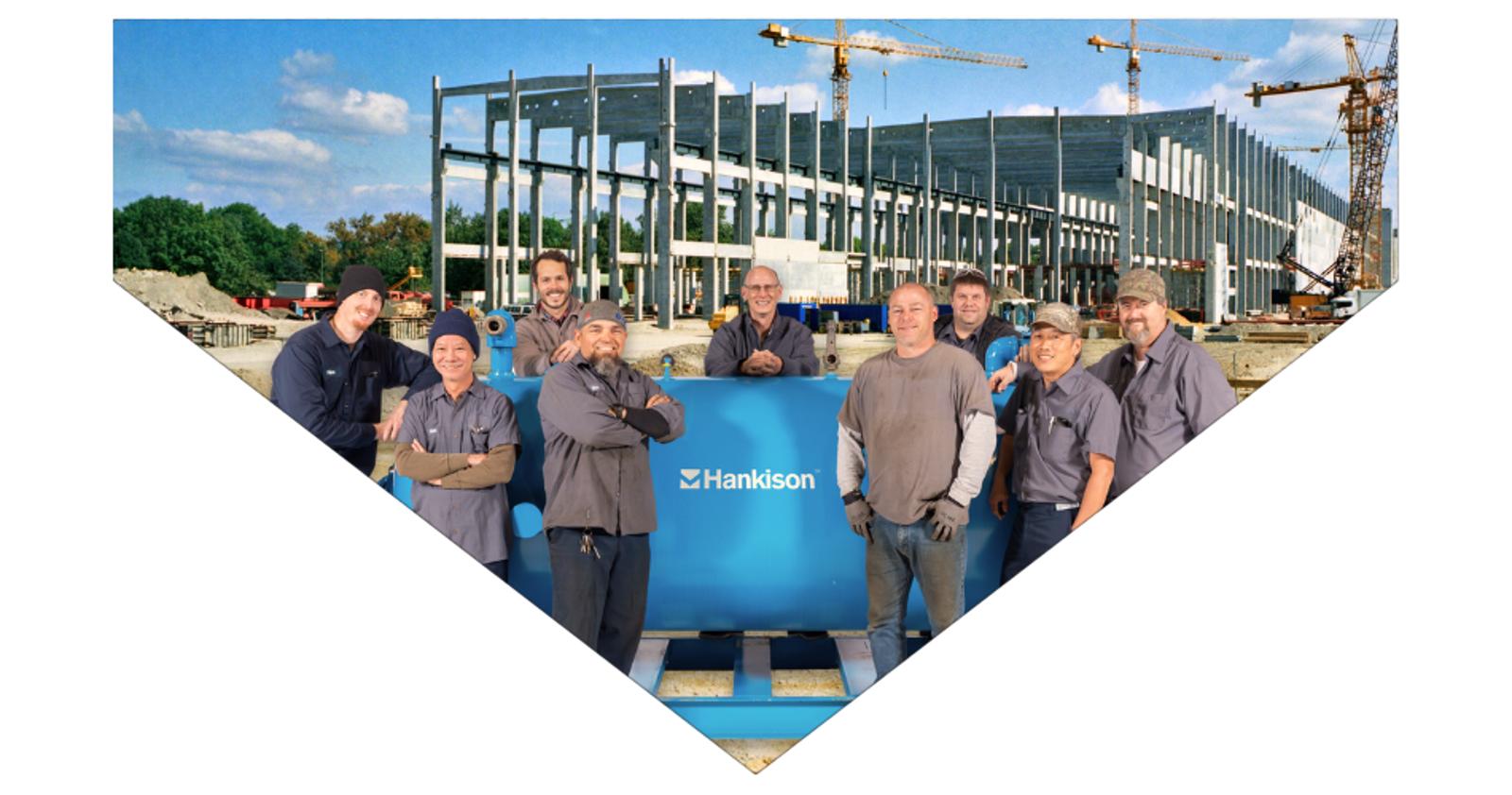 Hakison Rental team in front of a compressed air dryer on a construction site - banner