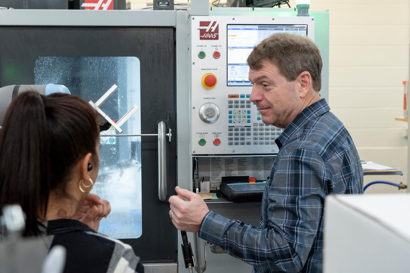 man-with-plastic-cnc-machine.jpg