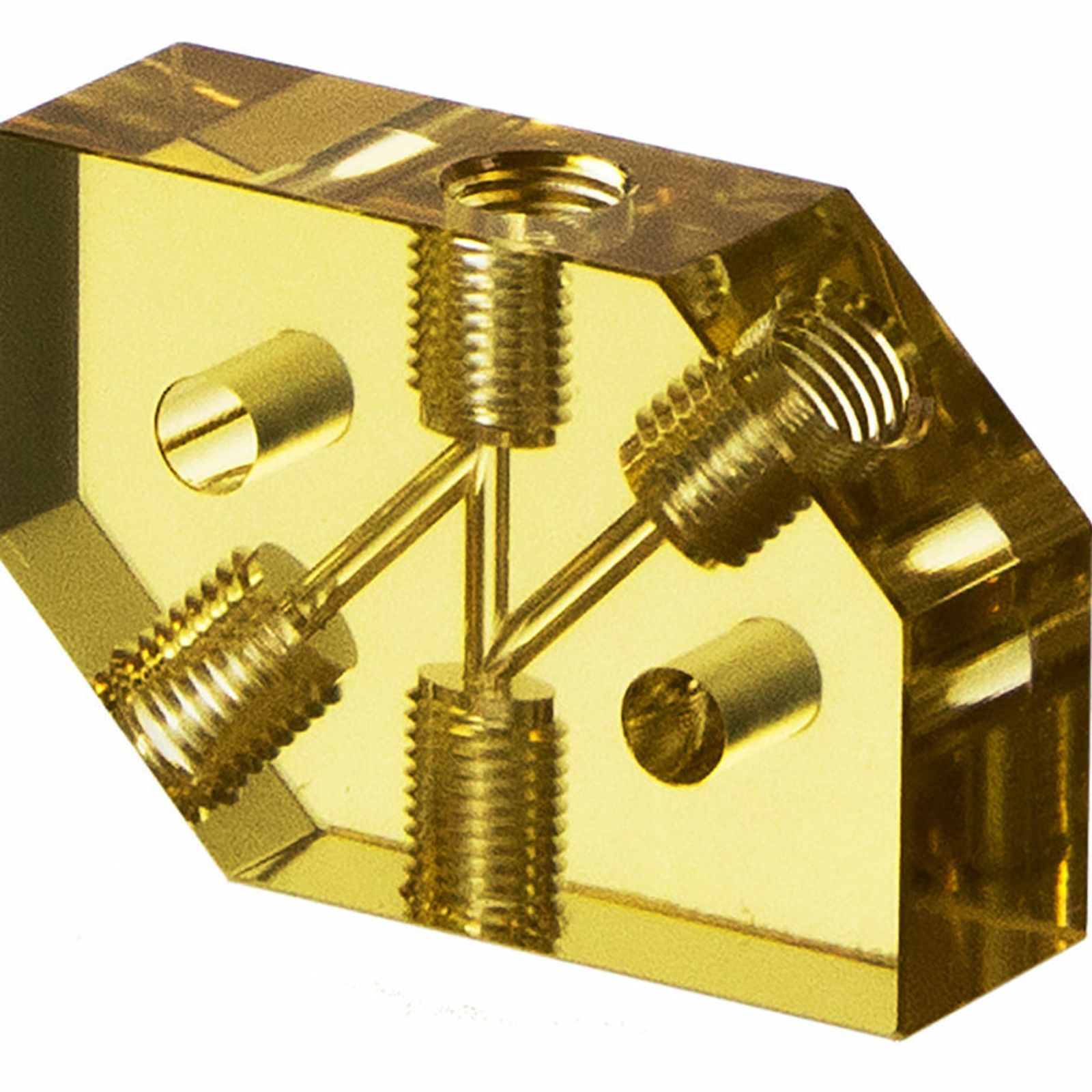 Transparent yellow ULTEM plastic component with multiple threaded inserts and intersecting drilled channels, viewed at an angle, demonstrating internal structure and engineering details.