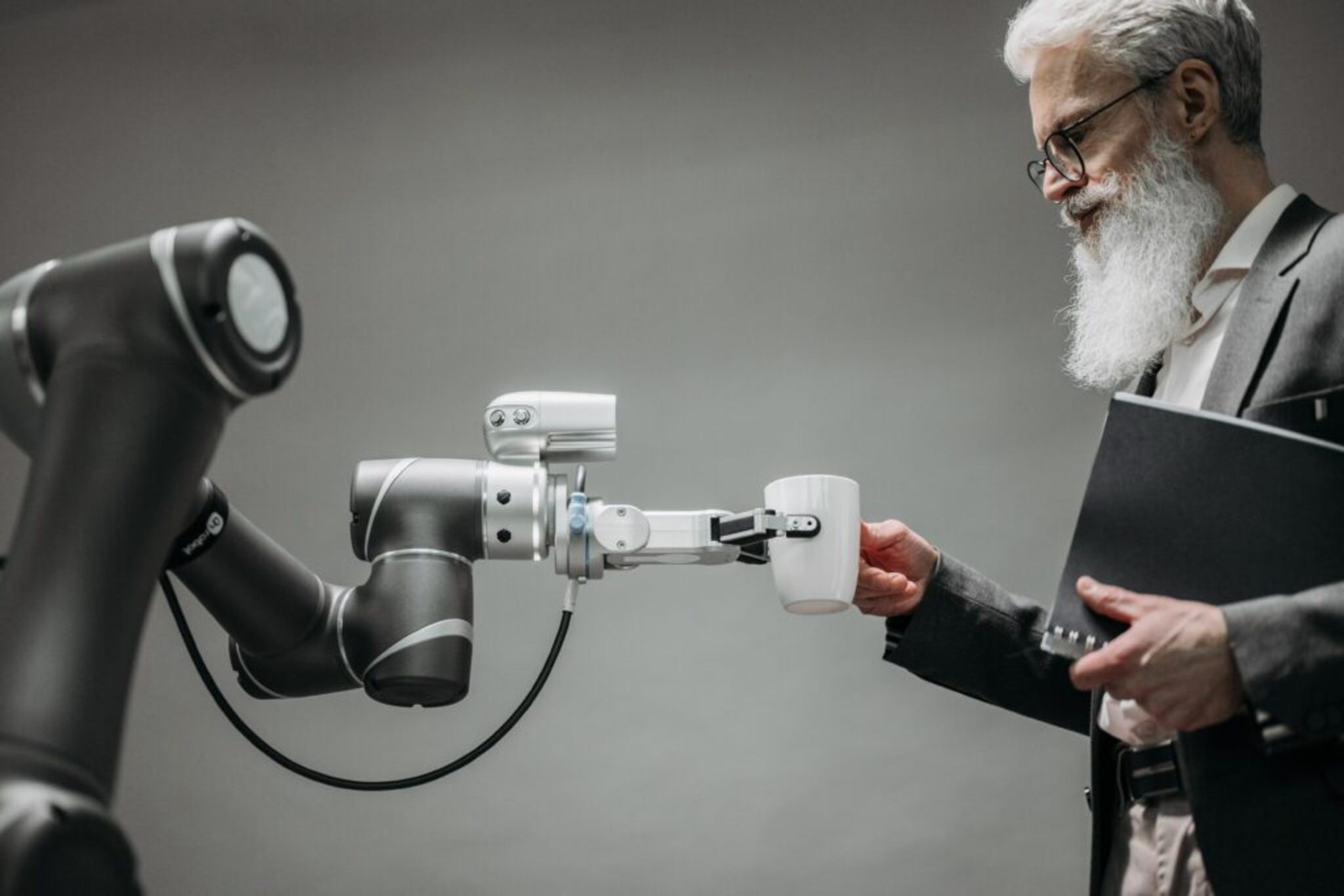 mature-man-taking-coffee-cup-from-robot-hand-1024x684.jpg