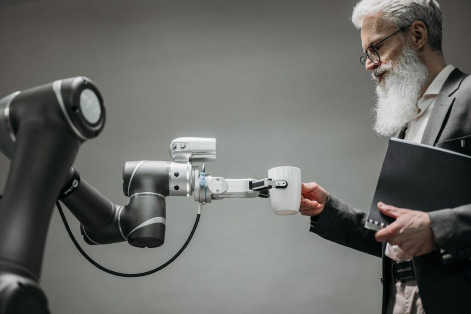 mature-man-taking-coffee-cup-from-robot-hand-1024x684.jpg