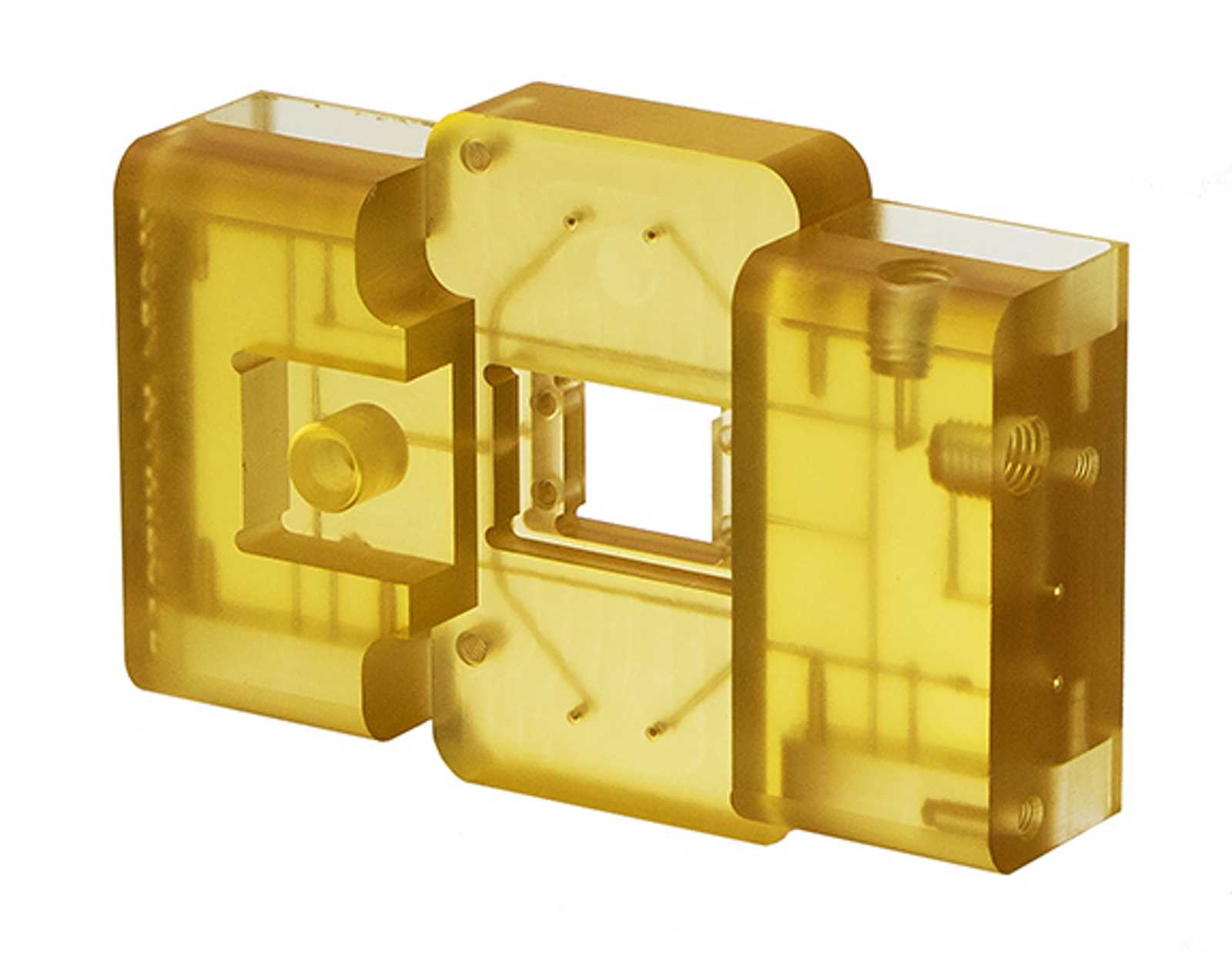 A translucent yellow polysulfone plastic component with rectangular and cylindrical shapes, featuring a central square opening and several internal structures, viewed on a white background.