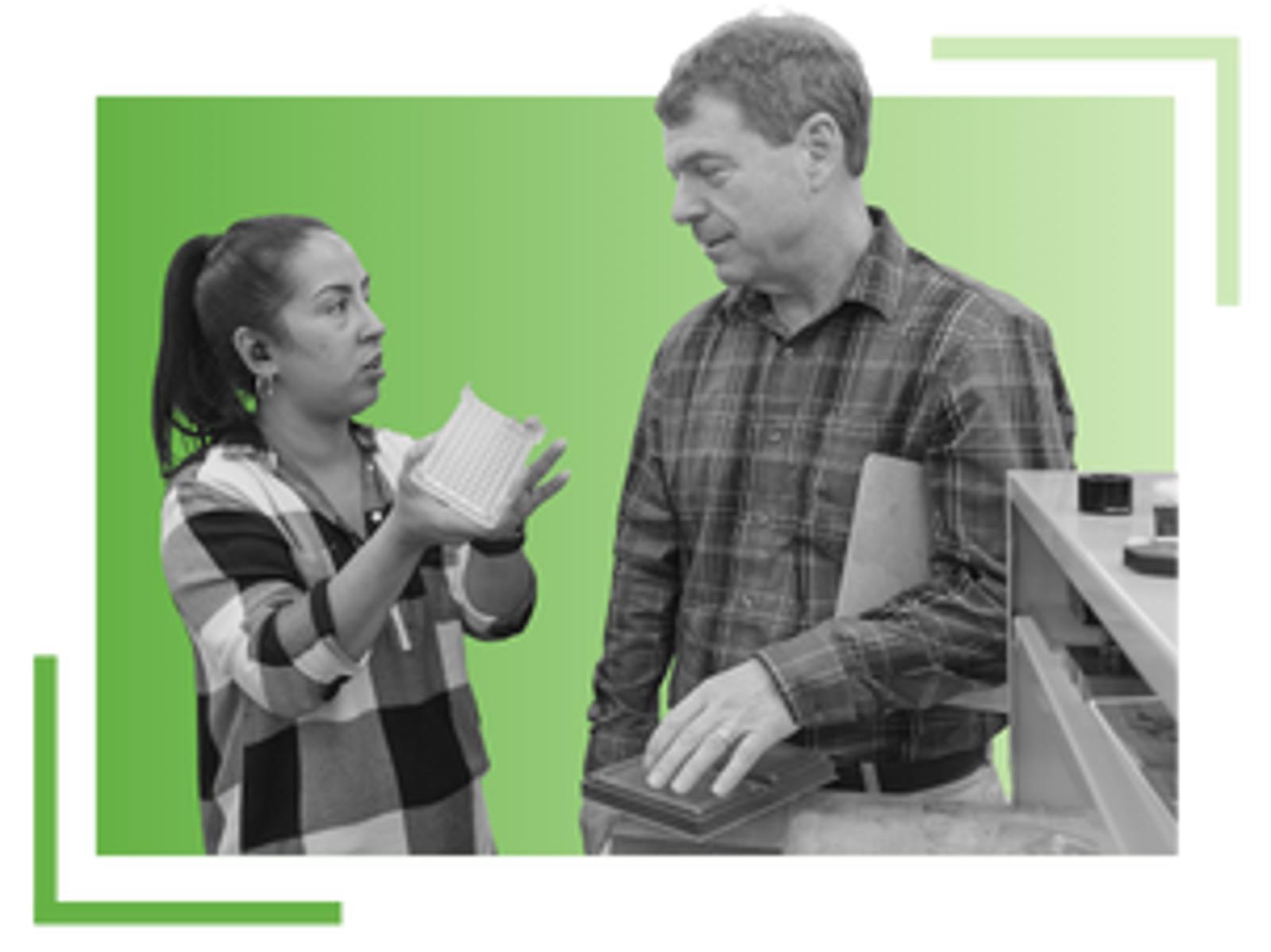 A woman talking to a man while holding a notepad. The man is holding a closed laptop. Both are standing in front of a green gradient background with decorative corner lines.