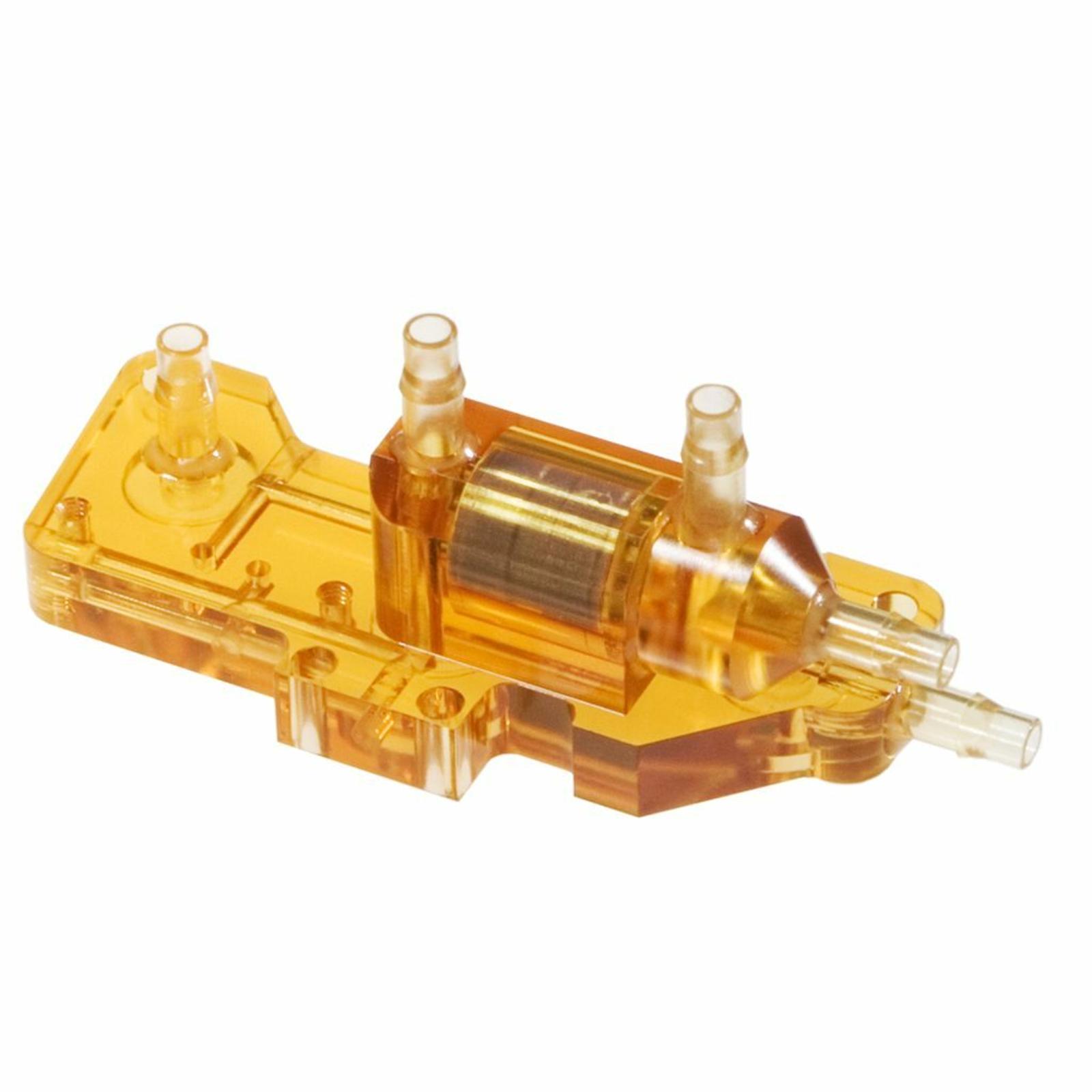 Transparent amber-colored ULTEM plastic medical component with cylindrical and tubular connectors, used for fluid handling and analysis in laboratory and clinical equipment.