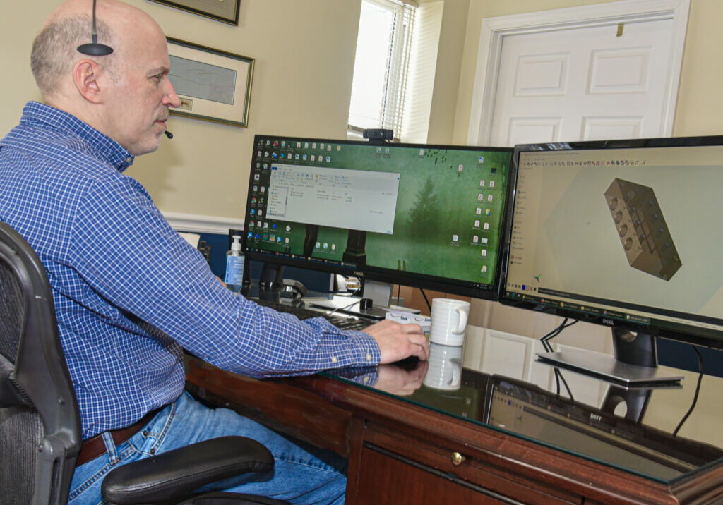 tom-sitting-at-computer-with-headset-.jpg