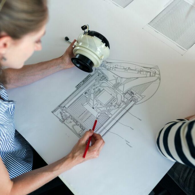 two-people-around-engineering-drawing-aerospace-1024x683-square.jpg