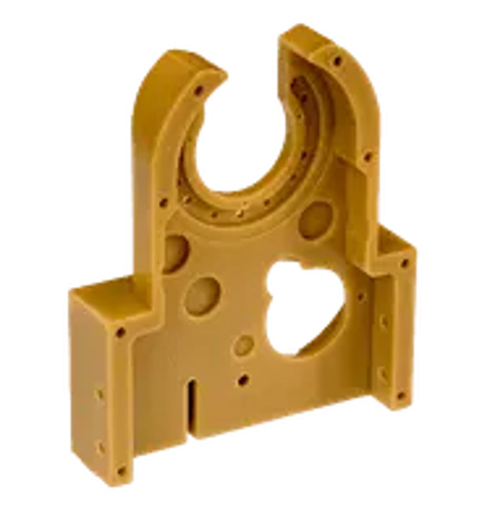 A tan ULTEM plastic bracket with a large circular cutout at the top, several smaller circular and rectangular holes, and structural arms on either side.