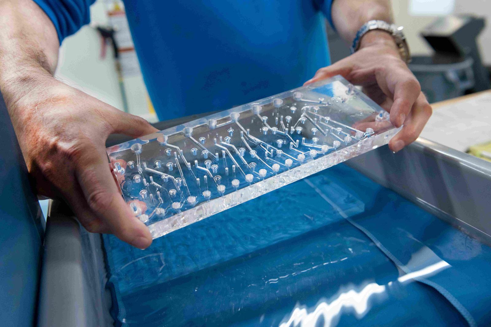 hands-holding-wet-acrylic-manifold.jpg