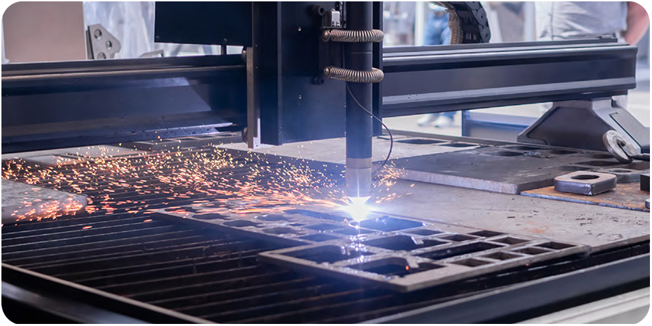 Fiber laser cutting on sheet metal with sparks, illustrating the need for a precise industri-al laser water chiller.