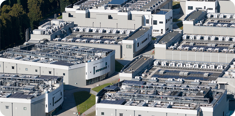 Aerial view of a large data center campus with extensive cooling and air conditioning infrastructure.