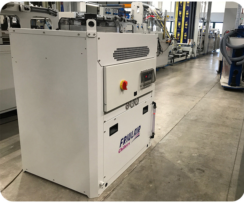 Friulair process chiller installed next to an injection molding line for precise mold cooling.