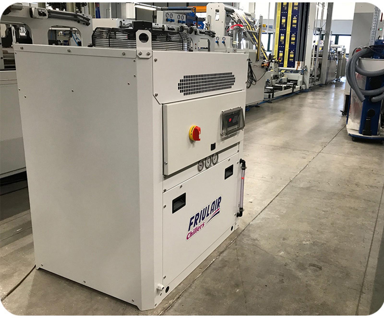 Friulair process chiller installed next to an injection molding line for precise mold cooling.
