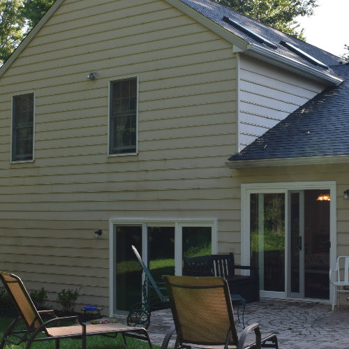 Exterior of home with windows and sliding glass door