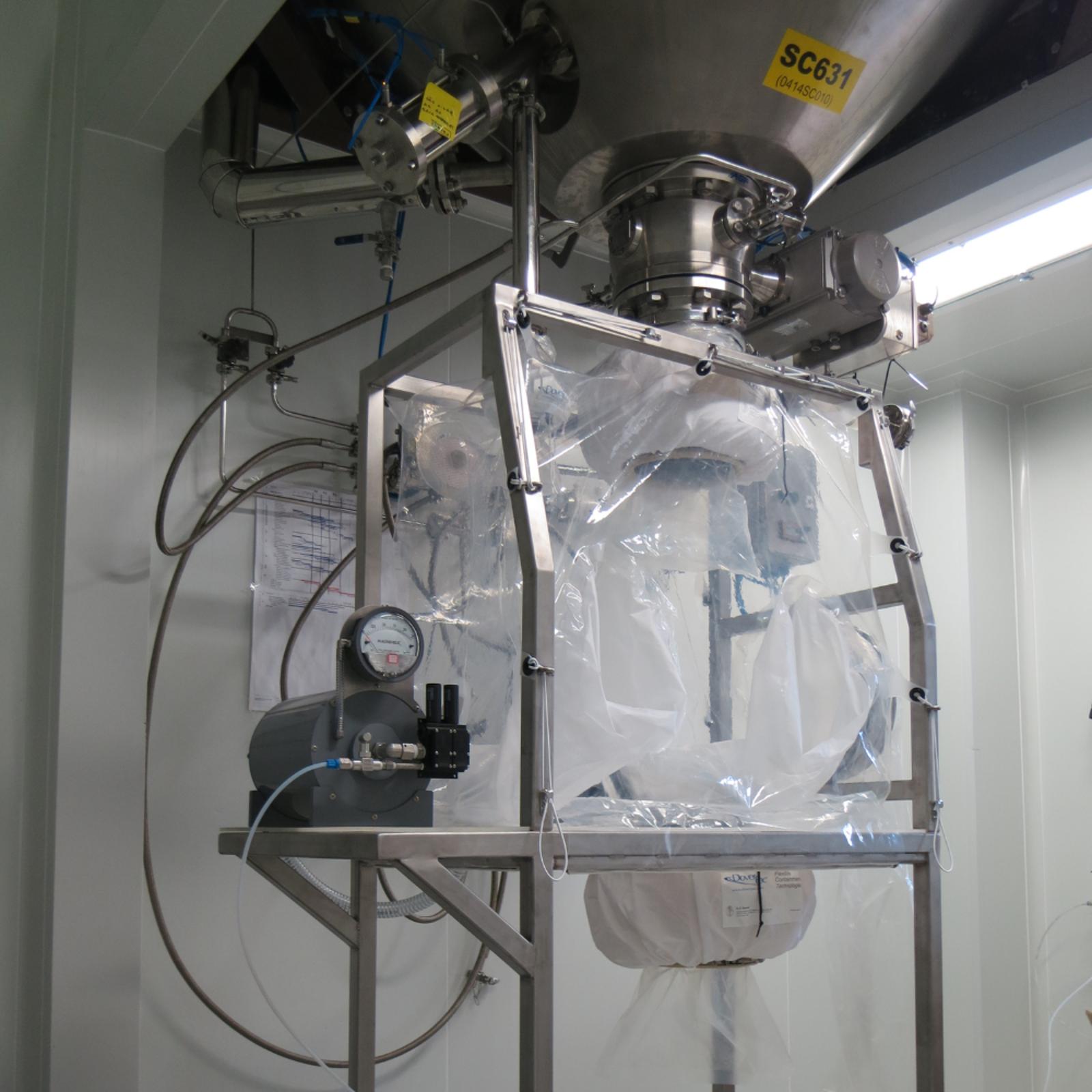 A metal rig with a sealed plastic container