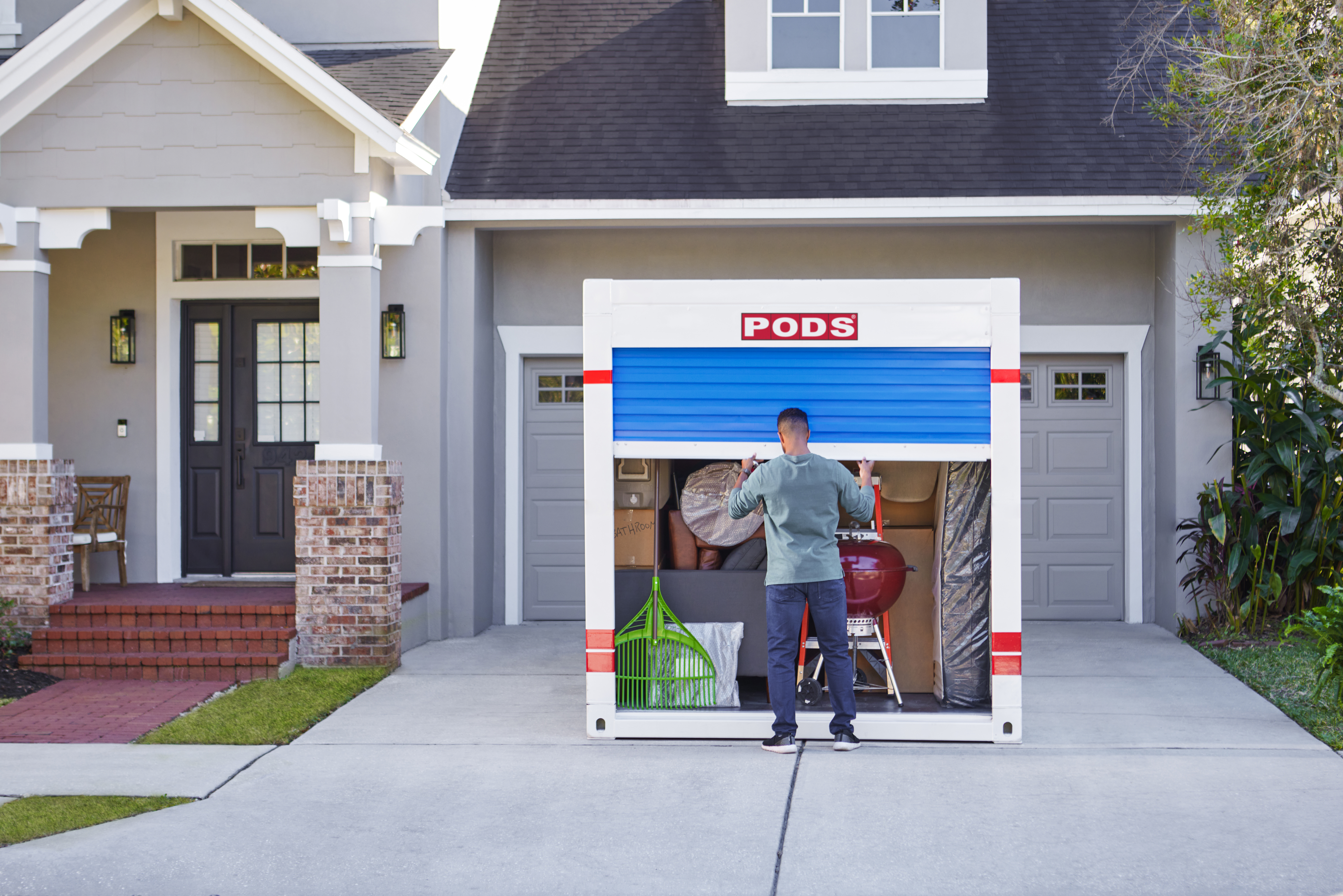 About PODS - Man opening a moving container in the driveway