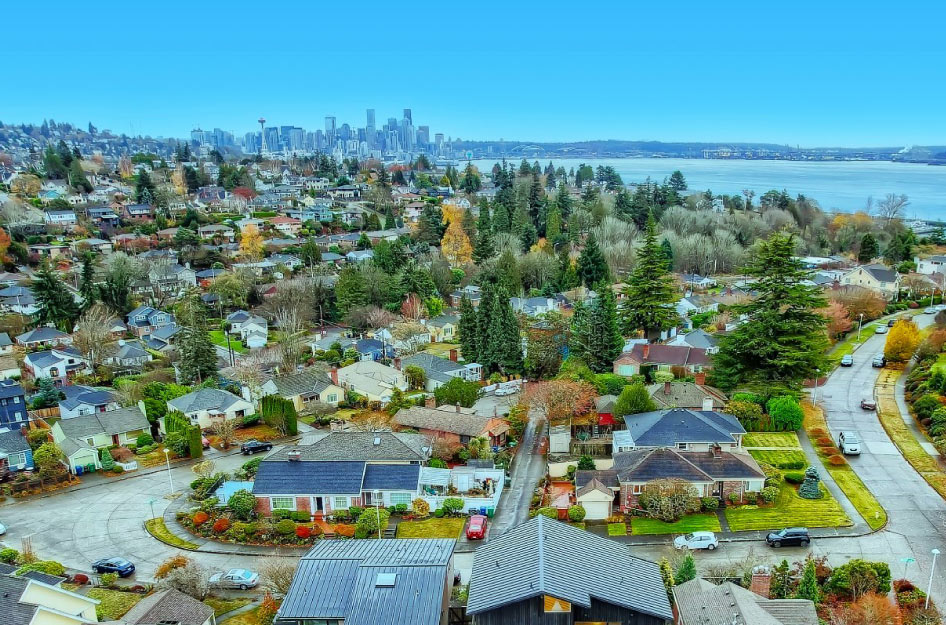Aerial view of one of the safest neighborhoods in Seattle — Magnolia — with the city’s skyline visible in the distance.