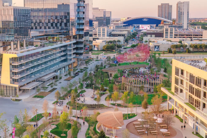 Aerial view of Frisco — one of the popular cities near Dallas — featuring new city buildings, green spaces, and the Ford Center in the background.