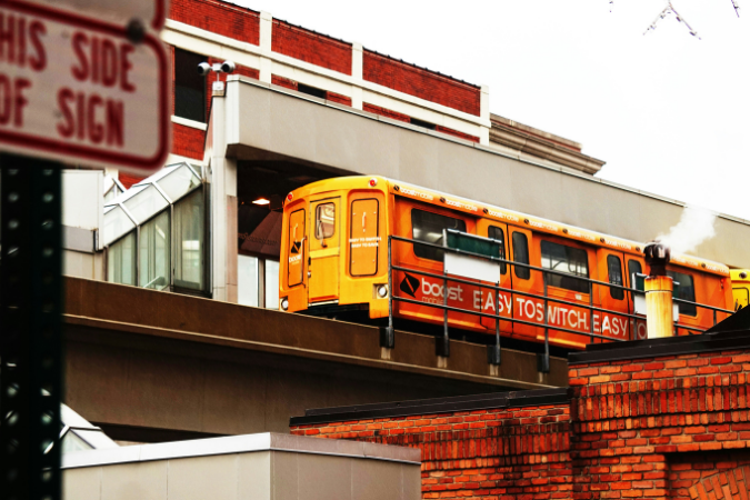 An image of a yellow train that is part of Detroit's public transport system.