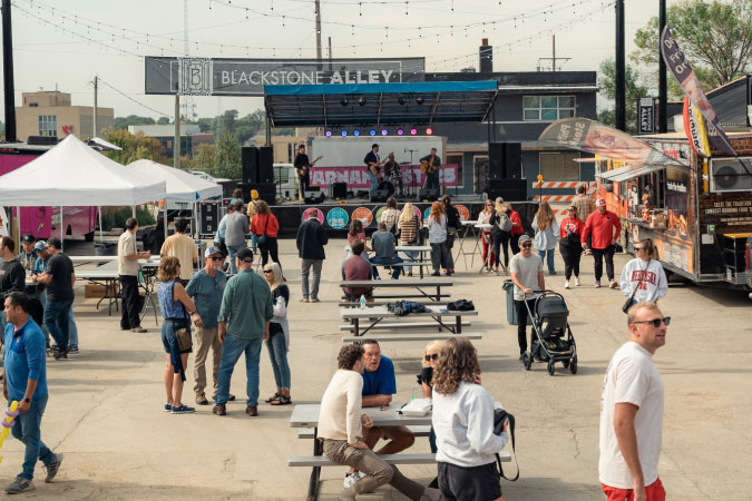 Dozens of locals gather for a food-truck, live-music event in Blackstone — one of the best Omaha neighborhoods.