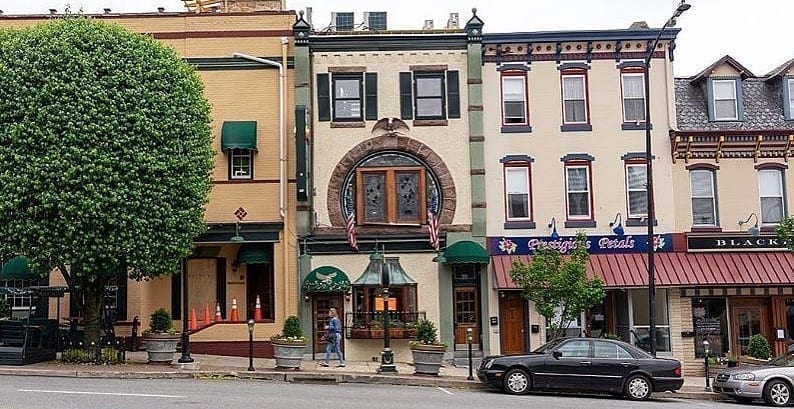 Street-level view of some of the shops along charming Fayette Street in Conshohocken (aka "Conshy"), Pennsylvania — one of the best Philadelphia suburbs.