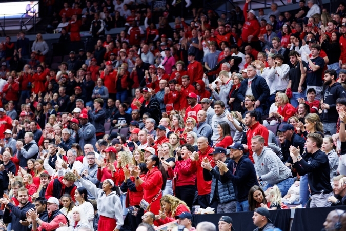 A stadium of fans cheer on the Louisville men’s basketball team at KFC Yum! Center in Louisville, KY.