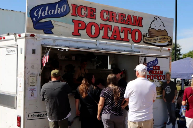 Close-up view of line of customers waiting outside of Idaho Ice Cream Potato food truck at Boise’s Potato Days festival in Boise, Idaho.