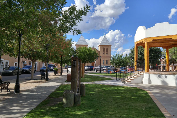 Historic Mesilla Plaza in Mesilla, NM — one of the best El Paso suburbs — featuring shaded walkways and a gazebo.