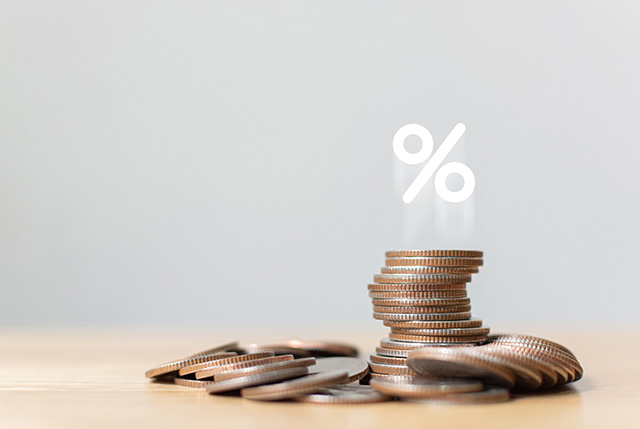 A stack of coins with a percent symbol floating above it, representing gathering interest