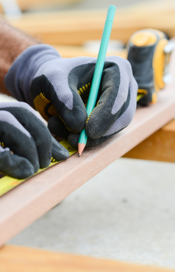 Construction Worker measuring wood